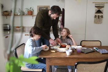 A father and his children having their breakfast at home