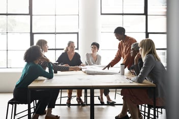 Businesswomen discussing by table in office