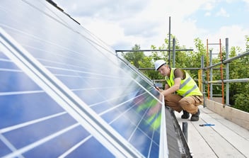 Caucasian technician working on solar panels