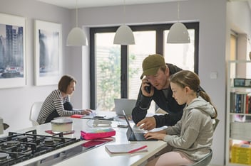 Girl studying at home whilst parents work from home