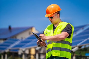 Green energy worker is conducting on-site inspection visit at the new energy base.