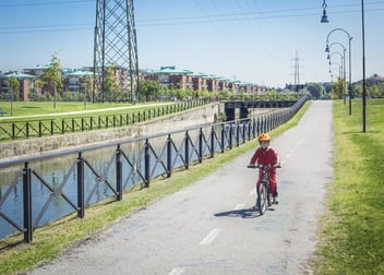 Little Boy Cycling On Line Near Canal