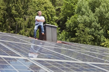 Man standing on solar paneled roof