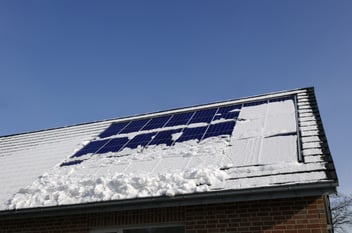 Snow covered solar panels on the roof