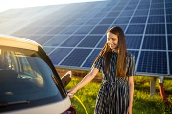 Woman charging an electric car