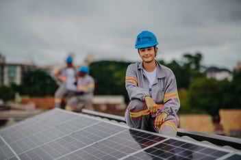 woman working on installation and maintenance of solar panels