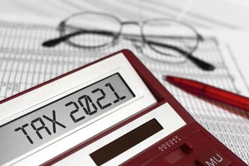 Word Tax 2021 on calculator. Glasses, pen and the calculator on documents. The concept of financial stability,Income Statement