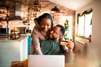 Young couple doing online Christmas shopping