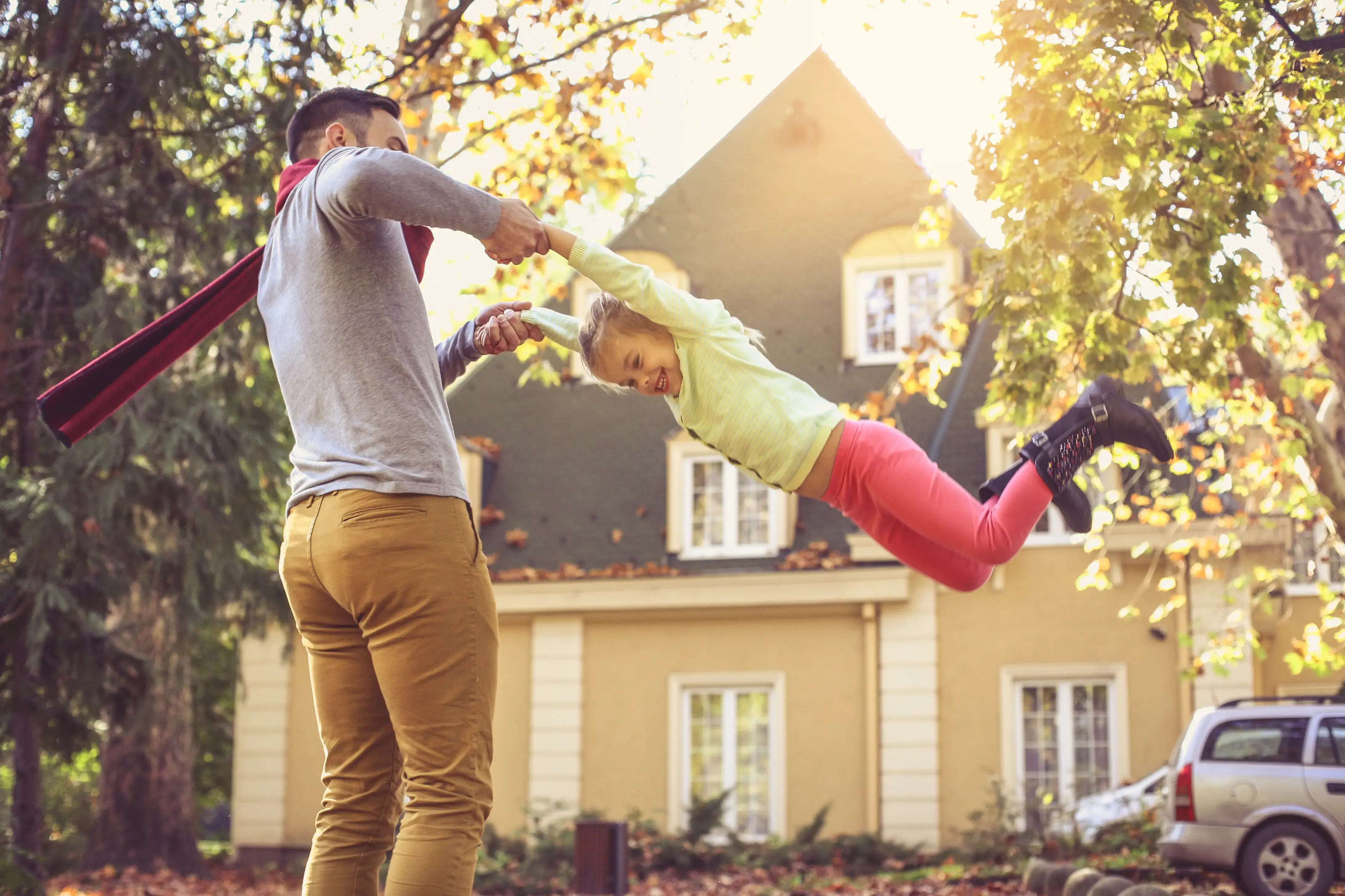 Happy family outside in colorful fall backyard.