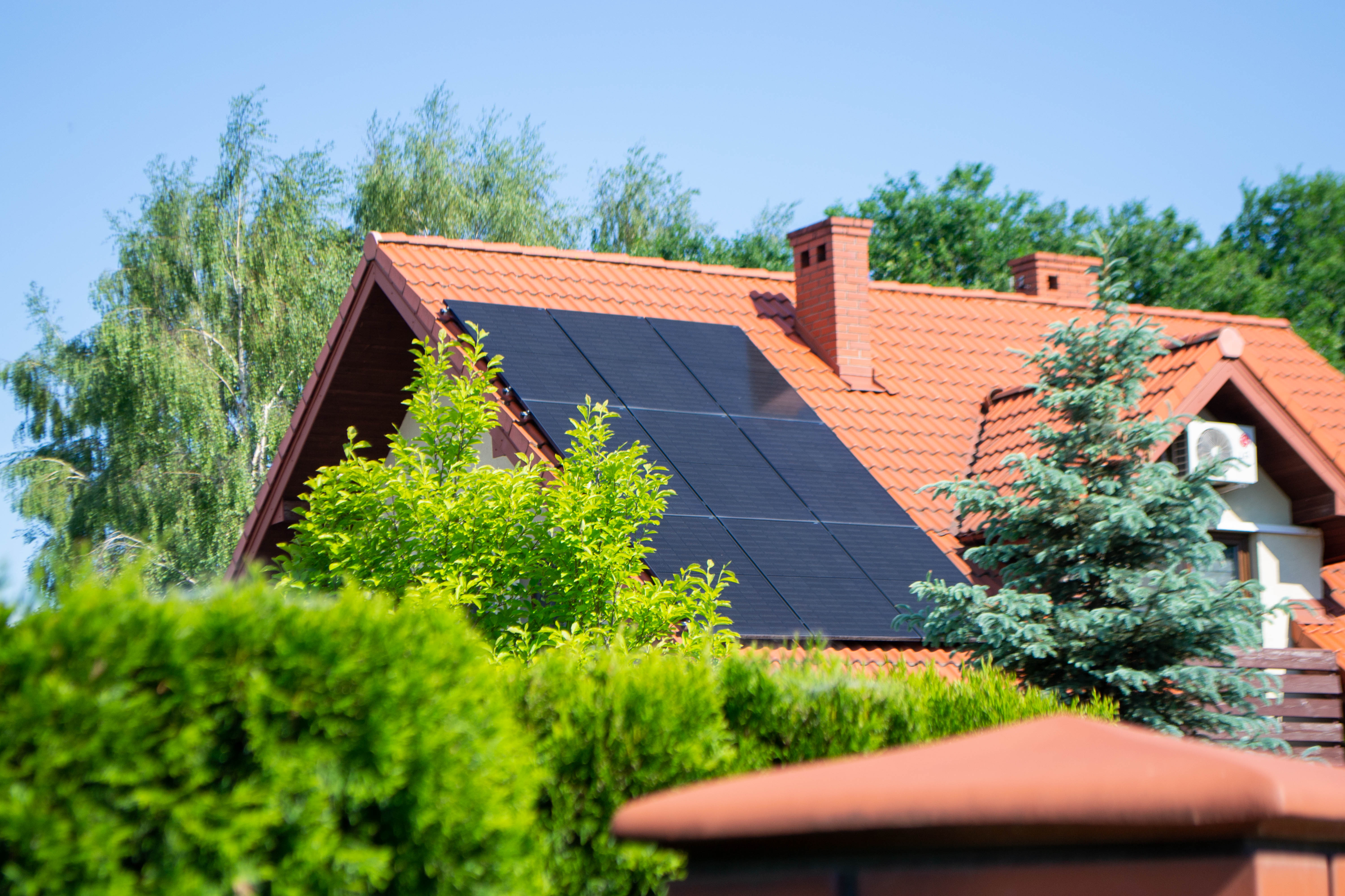 House roof with photovoltaic modules. Historic farm house with modern solar panels on roof and wall High quality photo