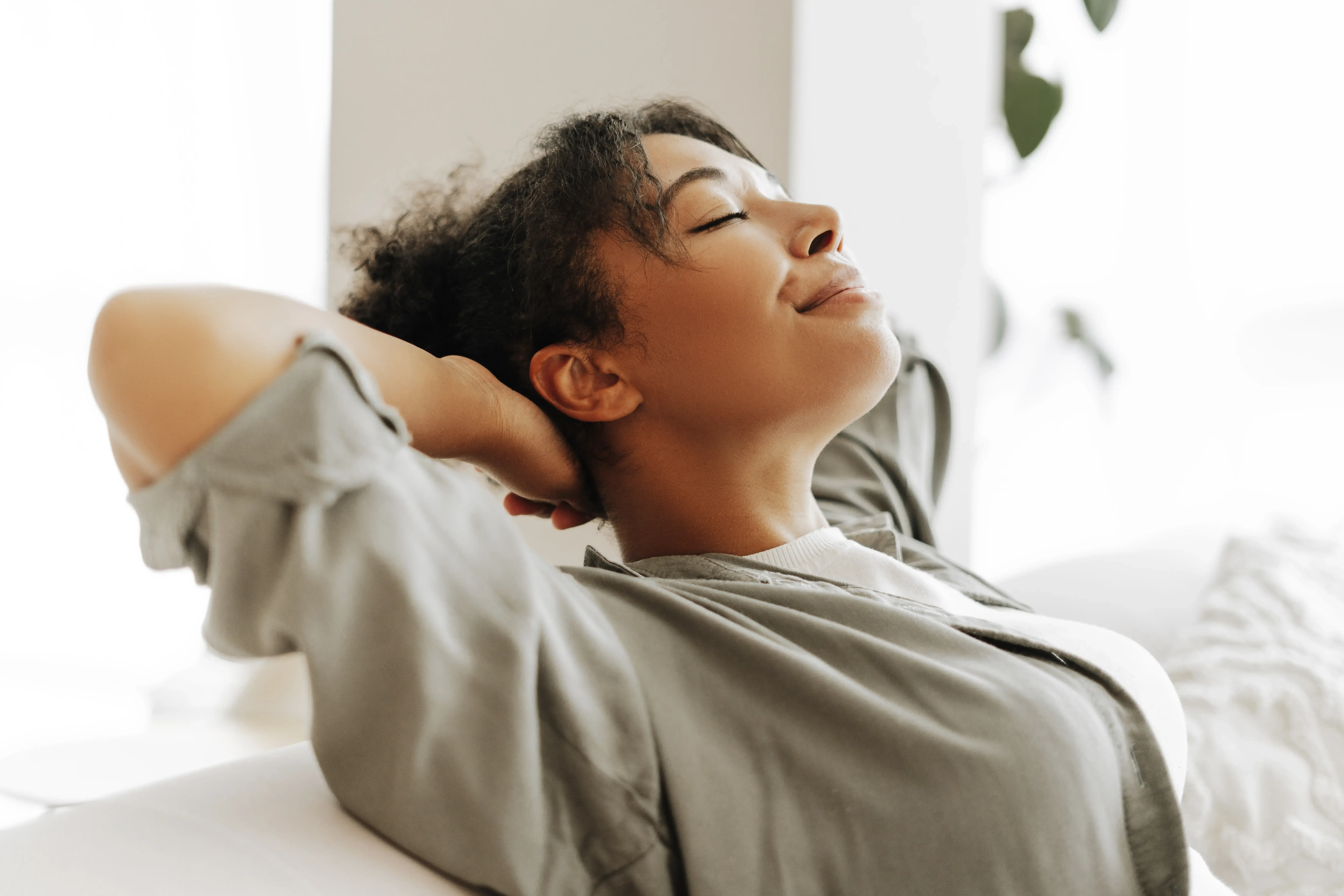 Young woman relaxing on comfortable sofa at home